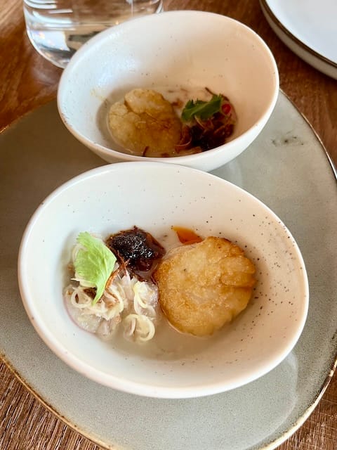 Picture of a scallop and lemongrass dish in a white round bowl