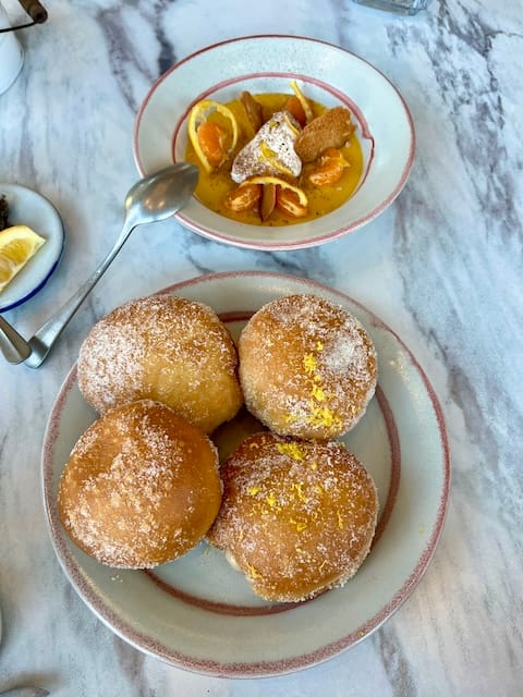 Picture of a plate of donuts and a bowl of pudding on a table