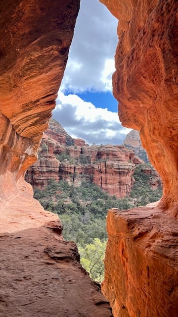 Photo of a cave overlooking a canyon.