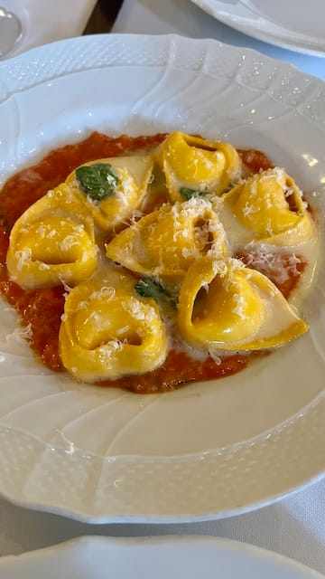 picture of a plate of tortellini pasta in red sauce