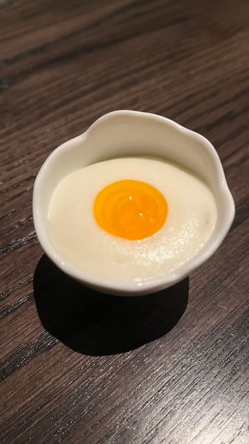 Picture of an egg dish in an egg shell-like dish