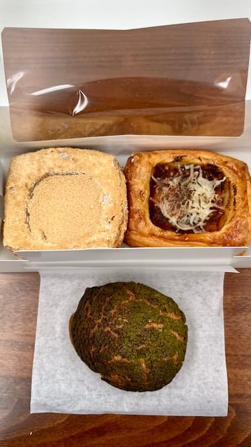 Picture of three pastries on a wooden table