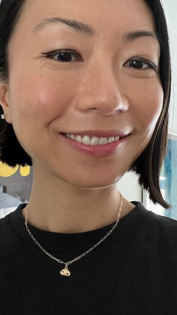 picture of a women wearing a black shirt and a gold necklace