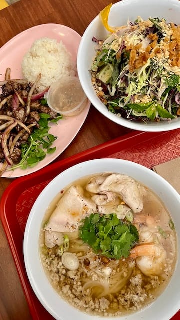 picture of a assorted dishes: beef and rice, cabbage salad, and a noodle soup