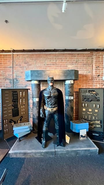 picture of a Batman costume on display at a museum
