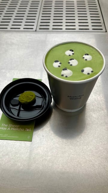 A picture of a cup of matcha with little sheep on top